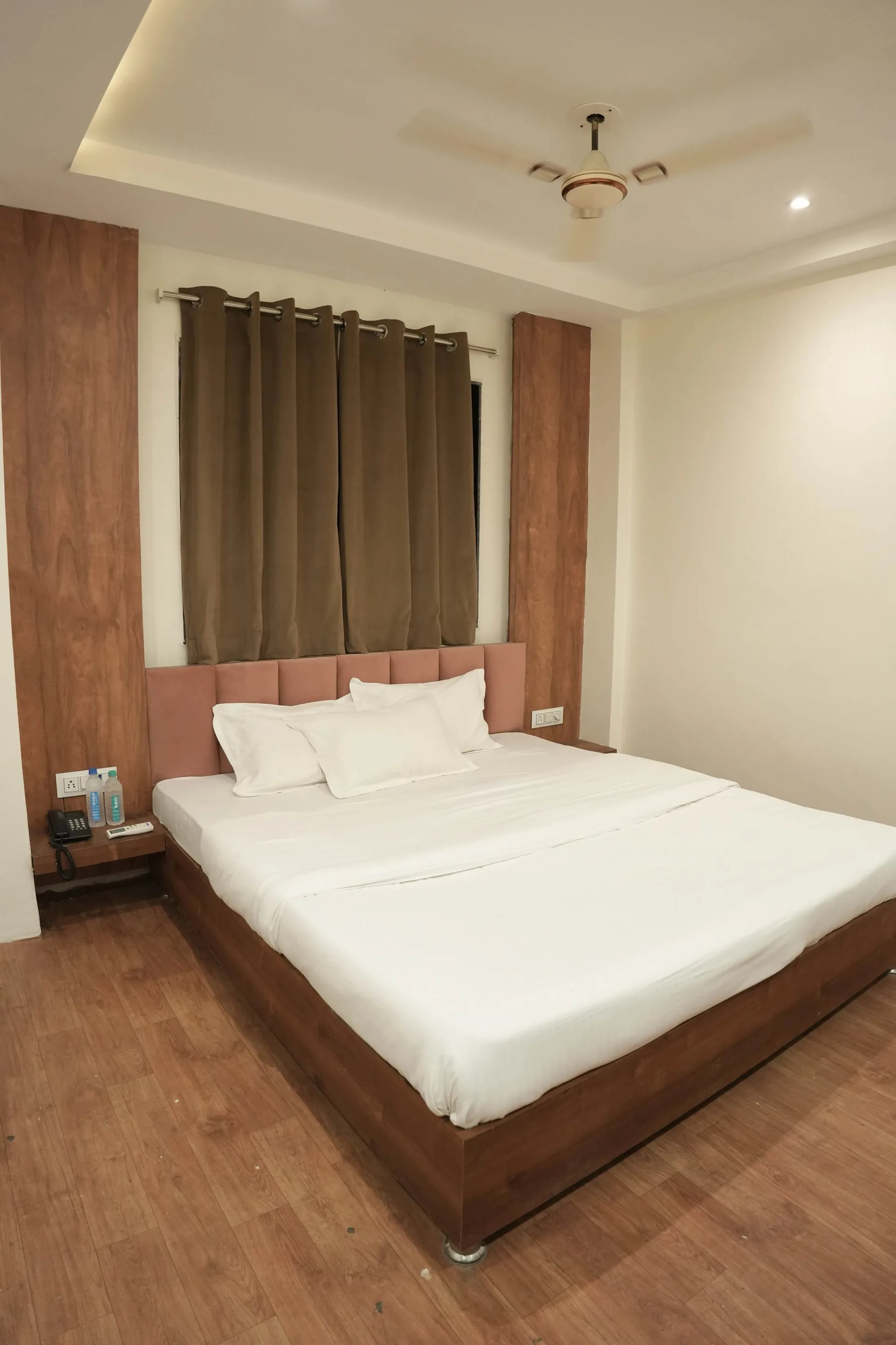 A guest room at Aariva, Ujjain, with a double bed, cushions and warm lighting